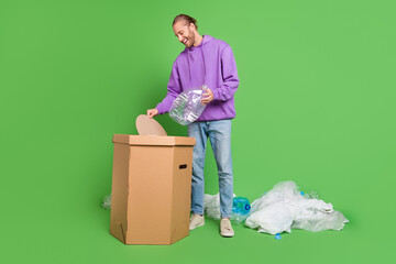 Photo of guy activist throw waste bin plastic bottle international world conservation concept isolated over green color background