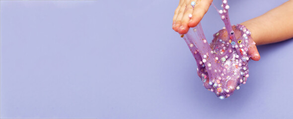 Making slime at home. child stretching colorful slime. DIY concept.