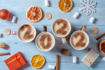 Card with numbers 2022 for New year and Christmas. Cup of coffee with figures on blue wooden background. Top view