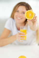 happy woman showing oranges to the camera