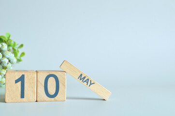 May 10, Calendar cover design with number cube with green fruit on blue background.	
