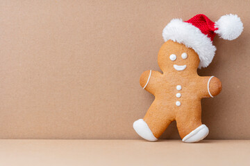 Gingerbread man, cookies and Christmas decor on pastel background.