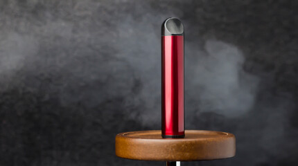 Electronic cigarette on a black background with smoke.