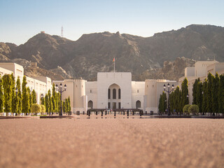 View of the National museum of Oman in Muscat with mountains on the background during the day.