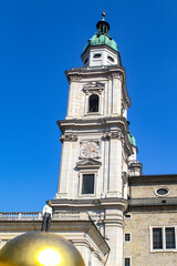 Austria. Spring. Day. Salzburg. View of the sculpture of Mozartkugel, the very famous Mozart ball - round sweets. And the silhouette above is its inventor Paul Fuerst.