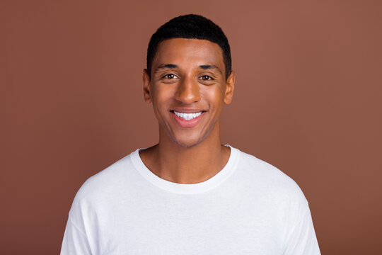 Photo of cheerful afrcian man good mood teeth veneers ceramic dentistry isolated over brown color background