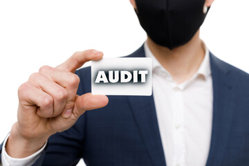 A businessman shows an inscription: AUDIT