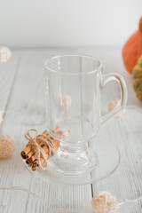 Cup with foam and cinnamon on background of pumpkins. Pumpkin autumn warming drink close-up and copy space...