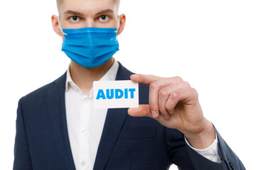 A businessman shows an inscription: AUDIT