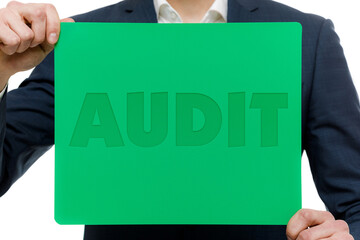 A businessman shows an inscription: AUDIT