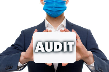 A businessman shows an inscription: AUDIT