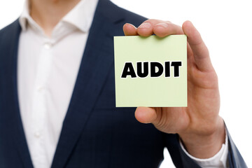 A businessman shows an inscription: AUDIT
