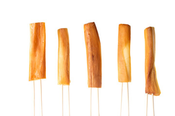 Cheese in the form of cheese sticks strung on wooden sticks on a white plate, isolate. Beer snack