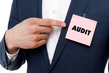 A businessman shows an inscription: AUDIT