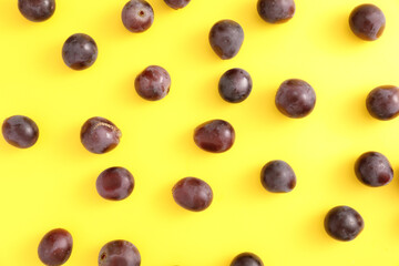 Red grapes isolated top view in yellow background