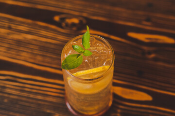 cold drink orange soda with ice, beverage cocktail on cafe table, juice refreshment
