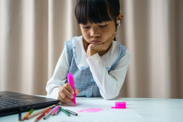 Pretty stylish schoolgirl studying homework art during her online lesson at home, social distance during quarantine, self-isolation, online education concept, home schooler