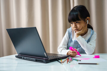 Pretty stylish schoolgirl studying homework art during her online lesson at home, social distance during quarantine, self-isolation, online education concept, home schooler