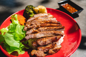 Thai style grilled pork with rice and vegetable, meal meat for dinner or lunch main dishes