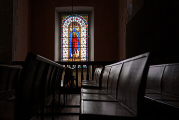 Church benches and stained-glass window in Saint-Louis Church, dedicated to Saint Louis (Louis the 9), grandfather of the King Louis XIV.. - obrazy, fototapety, plakaty
