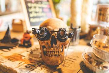 Halloween party concept decorate in cafe, decoration with human skull and pumpkin in holiday