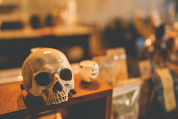 Halloween party concept decorate in cafe, decoration with human skull and pumpkin in holiday