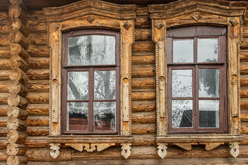 Old windows in a wooden log cabin