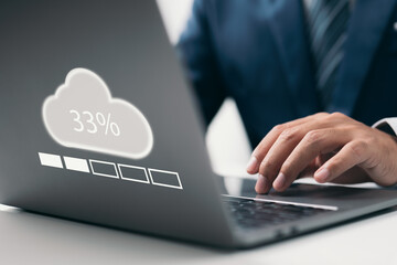 Man doing cloud uploading or downloading on laptop computer at office