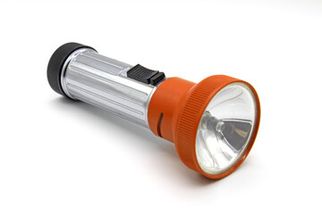 Vintage metal orange flashlight torch isolated on a white background