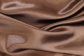 Brown satin fabric texture for background and design art work, beautiful crumpled pattern of silk...