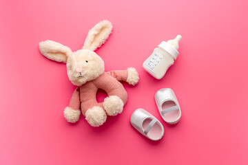Obraz na płótnie Canvas Baby girl pink shoes with milk and toy. Newborn set background