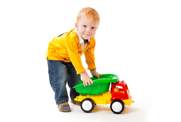 Little boy plays with toy truck