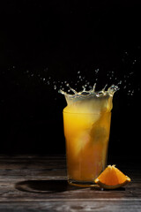 Orange juice splash in glass