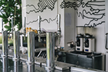 Stainless draft beer dispenser on counter bar