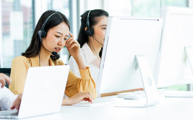 Asian beautiful attractive female call center stressful working with pressure with headsets,...