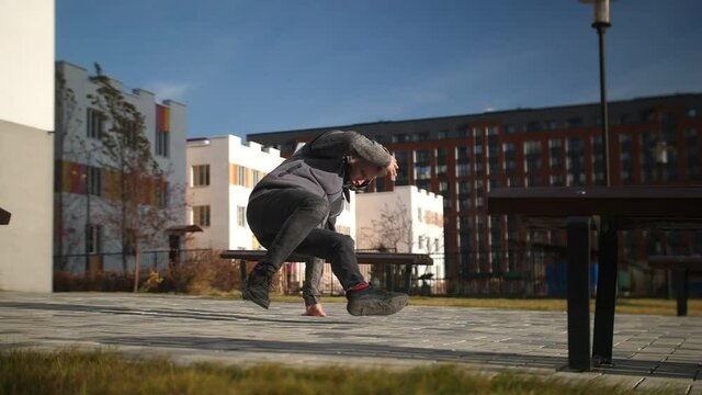 Shooting breakdancing in the city quarter. Slow motion video of a dancing man