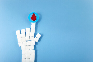 World diabetes day awareness. Blue circle with blood drop and hand shaped sugar cubes.