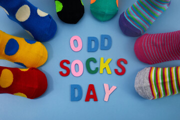 Fototapeta na wymiar Odd Socks Day. Day lost socks, lonely socks on blue background.