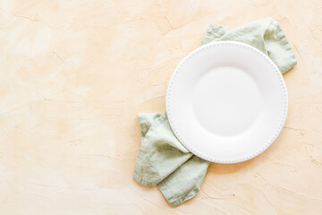 Fototapeta na wymiar Top view of empty plate on napkin. Table setting for dinner