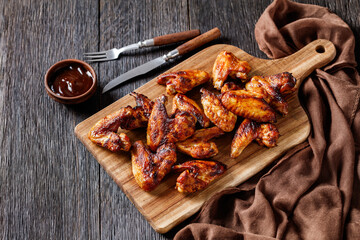 crispy fried chicken wings on a wooden board