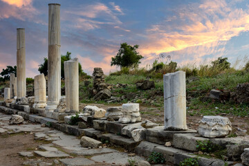 Ancient city ruins. Side Antalya. Colonnaded road and market place, Agora. Cloudy Sunset sky.