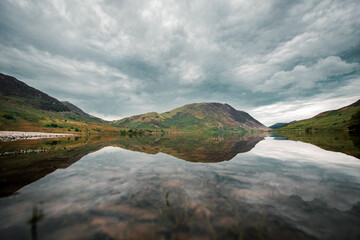 A landscape photograph looking across Crummock Water to the eastern fells of Buttermere Valley in the Lake District, Cumbria