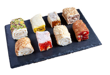 Turkish delight. Set of assorted Turkish delights with various flavors cream-filled. Lokum rolls covered nuts and sugar powder. Fruit jelly candy with hazelnut. isolated on white