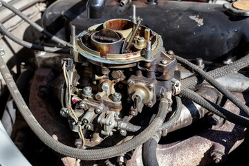 Disassembled carburetor on old engine without top and air filter. Carburettor motor Maintenance and...