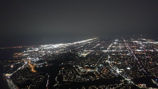 Airplane Aerial At Night Flying Over Major City With Heavy Fog Towards Lake Water 002