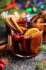 Glass mugs of mulled wine with spices and citrus fruits. Traditional hot drink or beverage, festive cocktail at X-mas or New Year