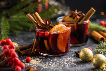 Glass mugs of mulled wine with spices and citrus fruits. Traditional hot drink or beverage, festive cocktail at X-mas or New Year