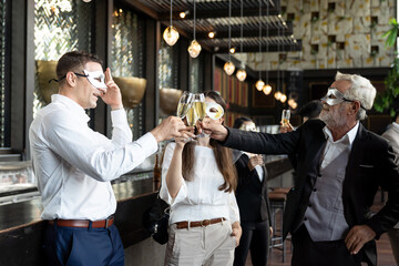 Group of diverse business people wear fantasy face mask and holding glasses of champagne for celebration in his company
