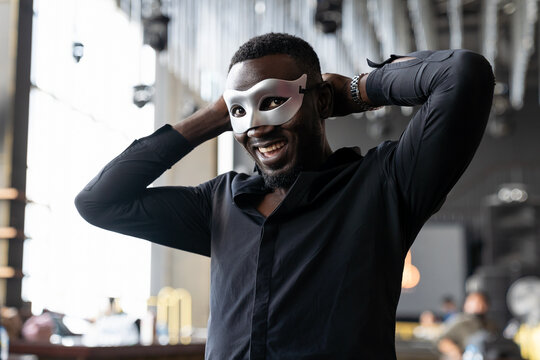 Smiling African American Man Wearing Fantasy Face Mask For Celebration In His Company