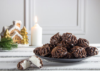 Marshmallow in chocolate on a light wooden background. New Year. horizontal side view.